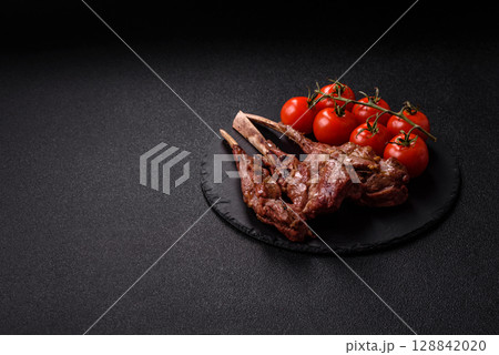 Juicy meat on the bone or rack of lamb. Grilled veal with salt, spices and herbs Juicy meat on the bone or rack of lamb. Grilled veal with salt, spices and herbs 128842020
