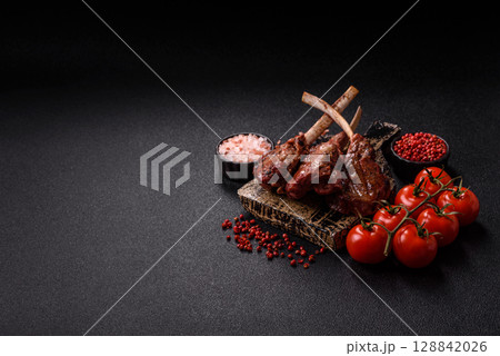Juicy meat on the bone or rack of lamb. Grilled veal with salt, spices and herbs Juicy meat on the bone or rack of lamb. Grilled veal with salt, spices and herbs 128842026