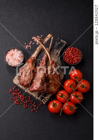 Juicy meat on the bone or rack of lamb. Grilled veal with salt, spices and herbs Juicy meat on the bone or rack of lamb. Grilled veal with salt, spices and herbs 128842027