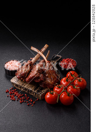 Juicy meat on the bone or rack of lamb. Grilled veal with salt, spices and herbs Juicy meat on the bone or rack of lamb. Grilled veal with salt, spices and herbs 128842028