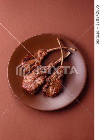 Juicy meat on the bone or rack of lamb. Grilled veal with salt, spices and herbs Juicy meat on the bone or rack of lamb. Grilled veal with salt, spices and herbs 128842035