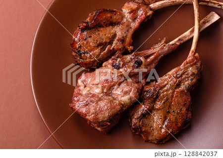 Juicy meat on the bone or rack of lamb. Grilled veal with salt, spices and herbs 128842037