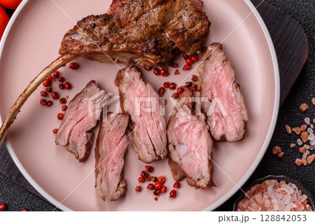 Juicy meat on the bone or rack of lamb. Grilled veal with salt, spices and herbs Juicy meat on the bone or rack of lamb. Grilled veal with salt, spices and herbs 128842053