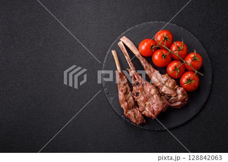 Juicy meat on the bone or rack of lamb. Grilled veal with salt, spices and herbs 128842063