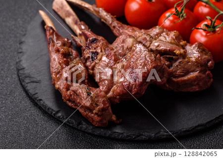 Juicy meat on the bone or rack of lamb. Grilled veal with salt, spices and herbs 128842065