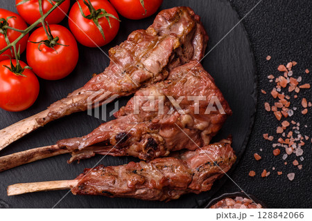 Juicy meat on the bone or rack of lamb. Grilled veal with salt, spices and herbs Juicy meat on the bone or rack of lamb. Grilled veal with salt, spices and herbs 128842066