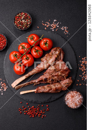 Juicy meat on the bone or rack of lamb. Grilled veal with salt, spices and herbs Juicy meat on the bone or rack of lamb. Grilled veal with salt, spices and herbs 128842068