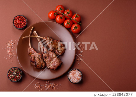 Juicy meat on the bone or rack of lamb. Grilled veal with salt, spices and herbs Juicy meat on the bone or rack of lamb. Grilled veal with salt, spices and herbs 128842077