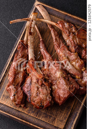 Juicy meat on the bone or rack of lamb. Grilled veal with salt, spices and herbs 128842079