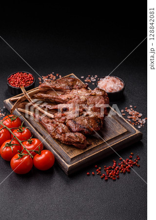 Juicy meat on the bone or rack of lamb. Grilled veal with salt, spices and herbs Juicy meat on the bone or rack of lamb. Grilled veal with salt, spices and herbs 128842081