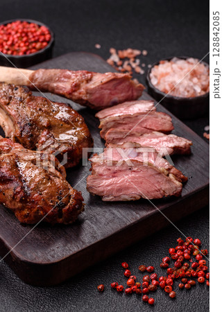 Juicy meat on the bone or rack of lamb. Grilled veal with salt, spices and herbs Juicy meat on the bone or rack of lamb. Grilled veal with salt, spices and herbs 128842085