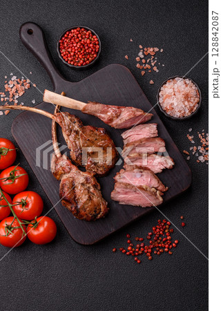 Juicy meat on the bone or rack of lamb. Grilled veal with salt, spices and herbs 128842087