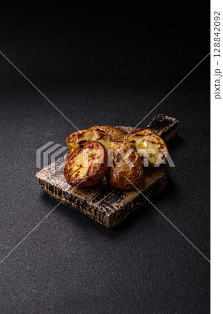 Food, potatoes cut in halves or slices grilled. Cooked baked potatoes Food, potatoes cut in halves or slices grilled. Cooked baked potatoes 128842092
