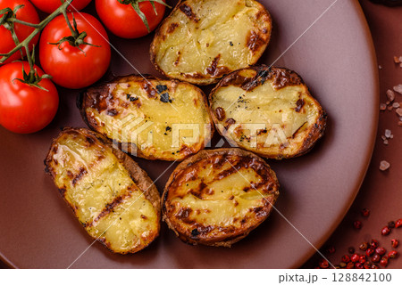 Food, potatoes cut in halves or slices grilled. Cooked baked potatoes 128842100