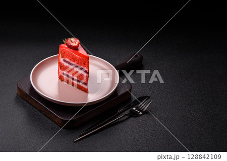 A piece of red velvet cake as a food background. Sweet pastries for celebration A piece of red velvet cake as a food background. Sweet pastries for celebration 128842109