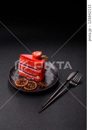 A piece of red velvet cake as a food background. Sweet pastries for celebration A piece of red velvet cake as a food background. Sweet pastries for celebration 128842115