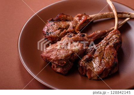 Juicy meat on the bone or rack of lamb. Grilled veal with salt, spices and herbs Juicy meat on the bone or rack of lamb. Grilled veal with salt, spices and herbs 128842145