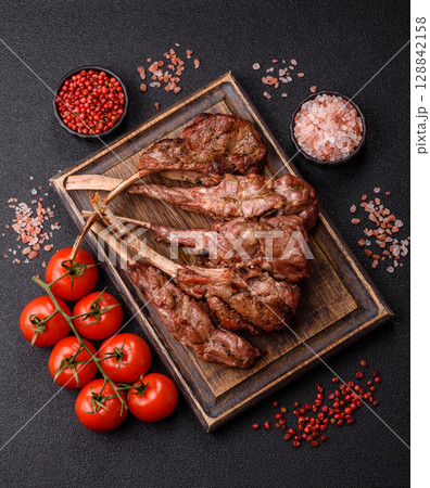 Juicy meat on the bone or rack of lamb. Grilled veal with salt, spices and herbs Juicy meat on the bone or rack of lamb. Grilled veal with salt, spices and herbs 128842158