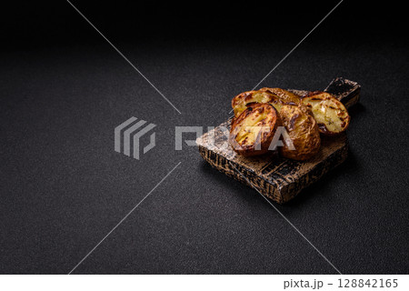 Food, potatoes cut in halves or slices grilled. Cooked baked potatoes 128842165