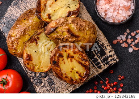 Food, potatoes cut in halves or slices grilled. Cooked baked potatoes Food, potatoes cut in halves or slices grilled. Cooked baked potatoes 128842169