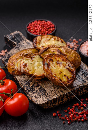 Food, potatoes cut in halves or slices grilled. Cooked baked potatoes Food, potatoes cut in halves or slices grilled. Cooked baked potatoes 128842170
