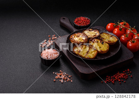 Food, potatoes cut in halves or slices grilled. Cooked baked potatoes 128842178