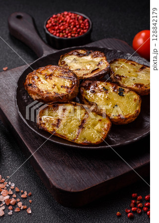 Food, potatoes cut in halves or slices grilled. Cooked baked potatoes Food, potatoes cut in halves or slices grilled. Cooked baked potatoes 128842179