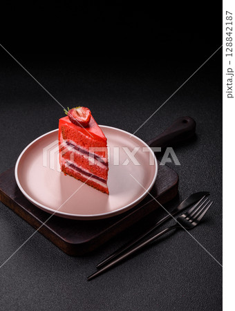 A piece of red velvet cake as a food background. Sweet pastries for celebration 128842187