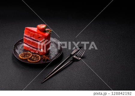 A piece of red velvet cake as a food background. Sweet pastries for celebration 128842192