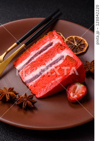 A piece of red velvet cake as a food background. Sweet pastries for celebration A piece of red velvet cake as a food background. Sweet pastries for celebration 128842220