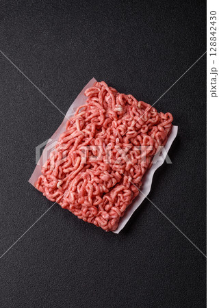 Raw ground beef or pork as an ingredient for burgers. Raw minced meat 128842430