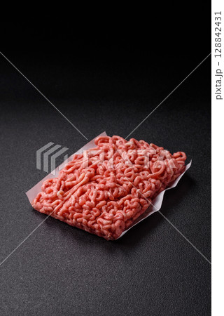 Raw ground beef or pork as an ingredient for burgers. Raw minced meat Raw ground beef or pork as an ingredient for burgers. Raw minced meat 128842431