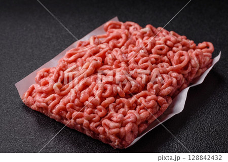 Raw ground beef or pork as an ingredient for burgers. Raw minced meat 128842432
