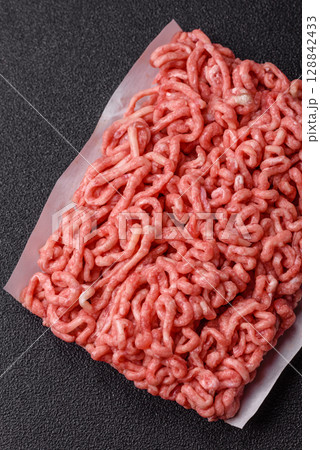 Raw ground beef or pork as an ingredient for burgers. Raw minced meat Raw ground beef or pork as an ingredient for burgers. Raw minced meat 128842433