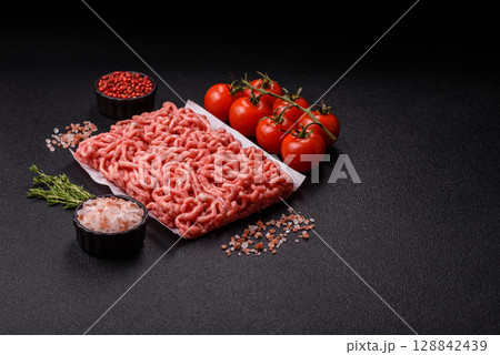 Raw ground beef or pork as an ingredient for burgers. Raw minced meat Raw ground beef or pork as an ingredient for burgers. Raw minced meat 128842439