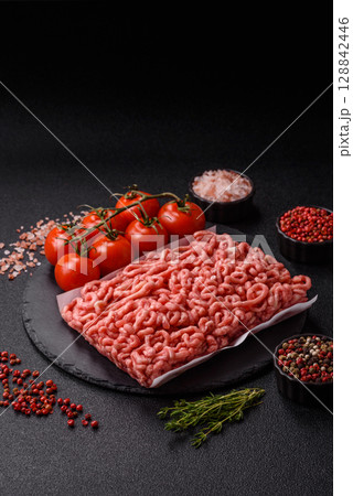 Raw ground beef or pork as an ingredient for burgers. Raw minced meat 128842446