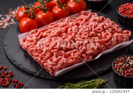 Raw ground beef or pork as an ingredient for burgers. Raw minced meat 128842447