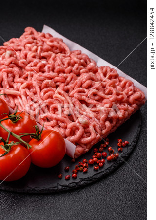 Raw ground beef or pork as an ingredient for burgers. Raw minced meat 128842454