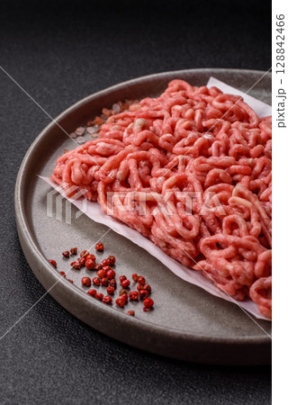 Raw ground beef or pork as an ingredient for burgers. Raw minced meat 128842466