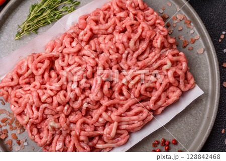Raw ground beef or pork as an ingredient for burgers. Raw minced meat Raw ground beef or pork as an ingredient for burgers. Raw minced meat 128842468