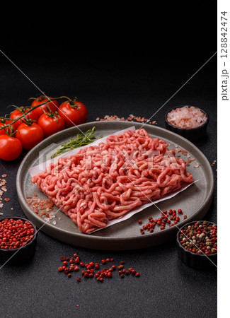 Raw ground beef or pork as an ingredient for burgers. Raw minced meat 128842474
