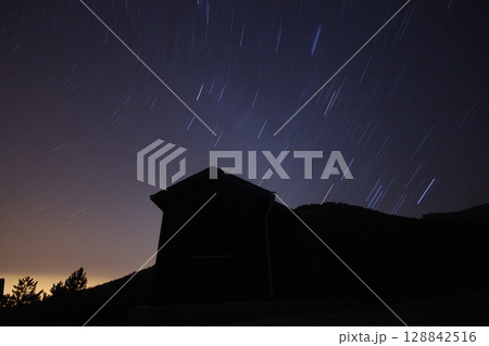 A view of the stars of the Milky Way with a mountain top in the foreground.Perseid Meteor Shower observation A view of the stars of the Milky Way with a mountain top in the foreground.Perseid Meteor Shower observation 128842516
