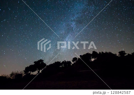A view of the stars of the Milky Way with a mountain top in the foreground.Perseid Meteor Shower observation A view of the stars of the Milky Way with a mountain top in the foreground.Perseid Meteor Shower observation 128842587