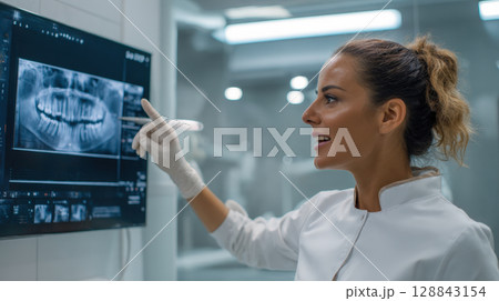 Skilled dental professional meticulously examines panoramic dental X-ray, showcasing dentistry, patient care. Concept of expertise, advanced technology, commitment to maintaining excellent oral health 128843154