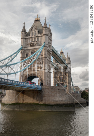 A low-angle view of London's iconic Tower Bridge (bascule and suspension bridge). 128845200