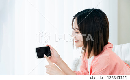 スマホを見る若い女性 128845535