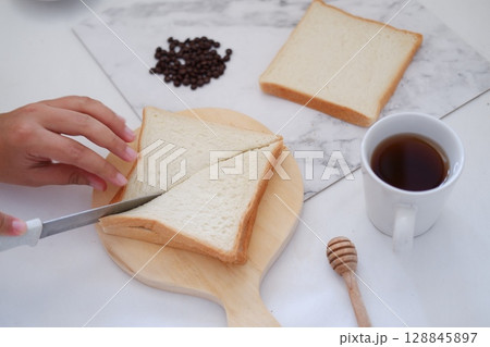 Cutting Toast for Breakfast 128845897