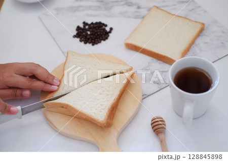 Cutting Toast for Breakfast 128845898