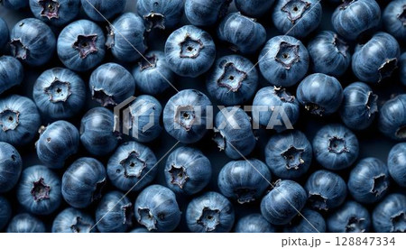 A close-up image of blueberries, capturing their freshness and color, arranged in a beautiful spring pattern 128847334