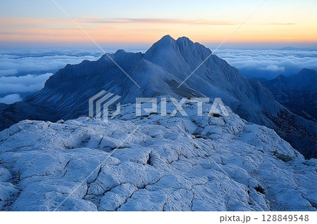 Serene Sunrise Over Snowy Peak and Cloud Sea Serene Sunrise Over Snowy Peak and Cloud Sea 128849548